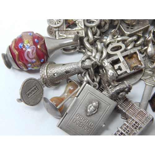 207 - Hallmarked Silver Charm Bracelet with Numerous Charms: Gross weight 134g