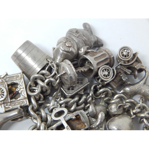 207 - Hallmarked Silver Charm Bracelet with Numerous Charms: Gross weight 134g