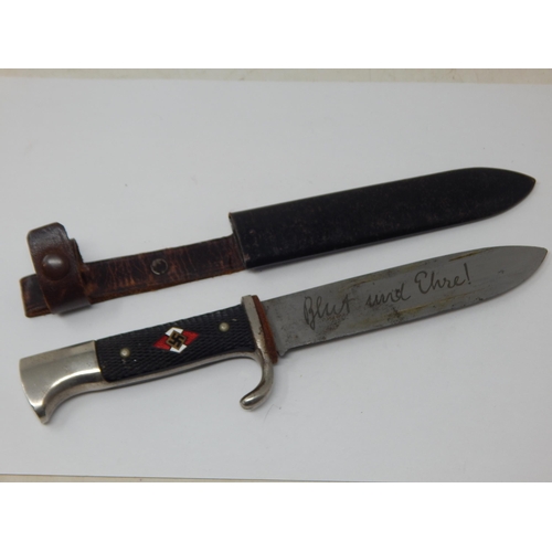 Third Reich Hitler Youth Dagger by K & Co, Solingen, black chequered two piece grip with enamel HJ diamond insignia to the centre. Housed in its original steel scabbard with leather belt loop attached. Blade with etched motto ‘Blut und Ehre!'