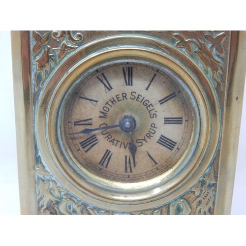 301 - MOTHER SEIGELS CURATIVE ADVERTISING CLOCK. 7.8ins tall, heavily embossed brass body in the shape of ... 