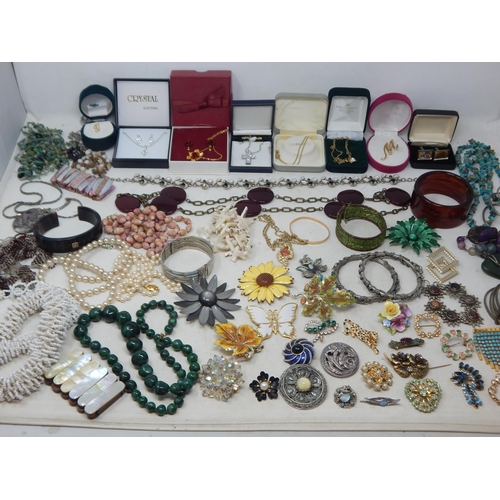 229 - A Huge Quantity of Vintage Costume Jewellery Including Brooches, Beaded Necklaces, Bangles etc (lot)