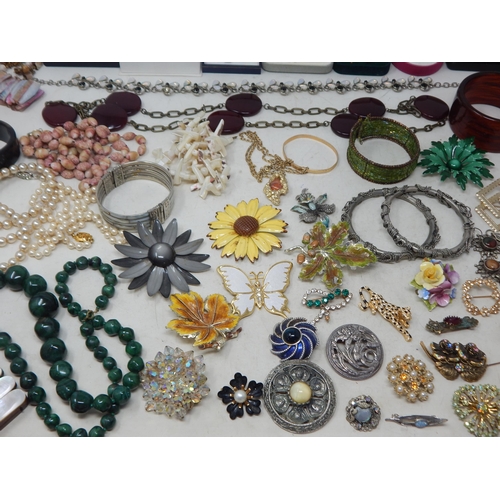 229 - A Huge Quantity of Vintage Costume Jewellery Including Brooches, Beaded Necklaces, Bangles etc (lot)