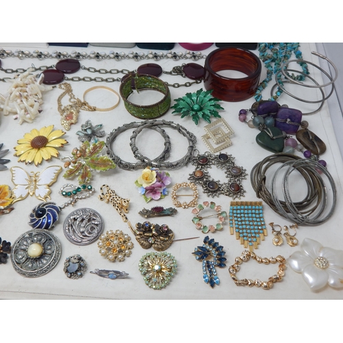 229 - A Huge Quantity of Vintage Costume Jewellery Including Brooches, Beaded Necklaces, Bangles etc (lot)