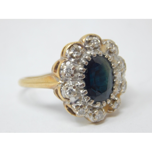 242 - 18ct Gold Sapphire & Diamond Ring: The Sapphire estimated @ 1.50cts within a border of 10 Diamonds. ... 