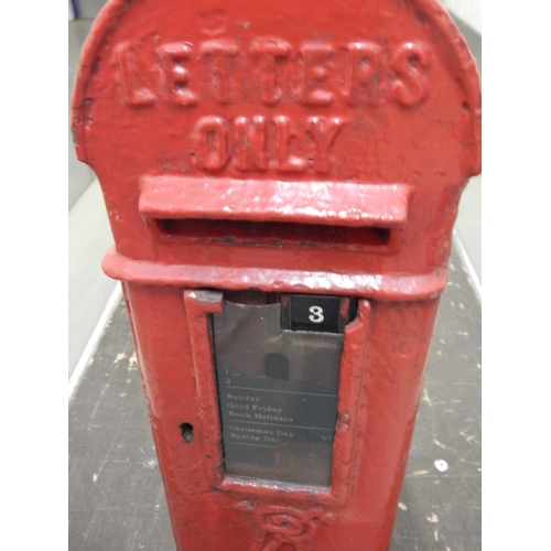 324 - A Victorian red painted cast iron wall mounted post box with key, 72cm tall