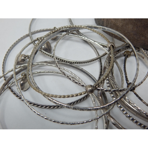 248 - A Quantity of Silver Bangles 160g together with white metal examples