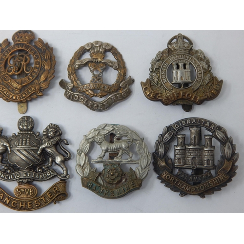 85 - Collection of Military Badges to Include: East Lancashire, Suffolk Regiment, Manchester, Hampshire, ... 