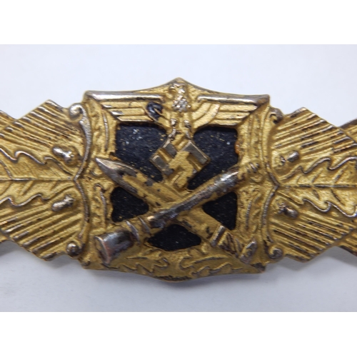 335 - German close combat clasp. The badge having a central Eagle and Swastika motif surmounting a crossed... 