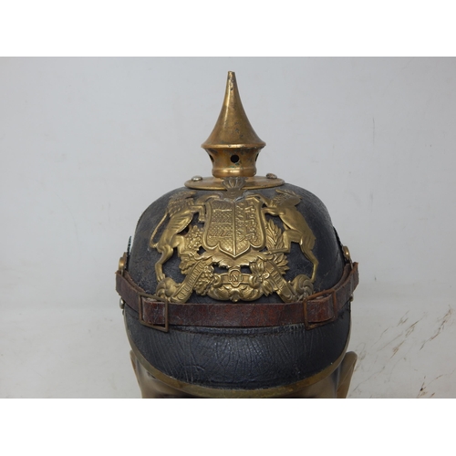 200 - A WWI Imperial German Army pickelhaube uniform helmet. Leather construction with brass front plate d... 