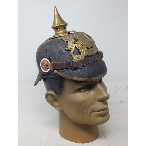 200 - A WWI Imperial German Army pickelhaube uniform helmet. Leather construction with brass front plate d... 