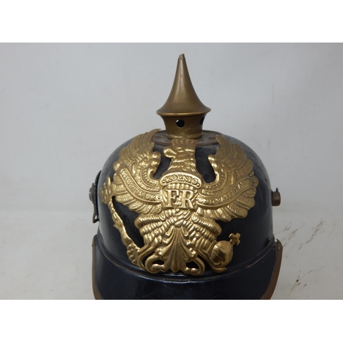 201 - A WWI Imperial German Army pickelhaube uniform helmet. Leather construction with brass front plate d... 
