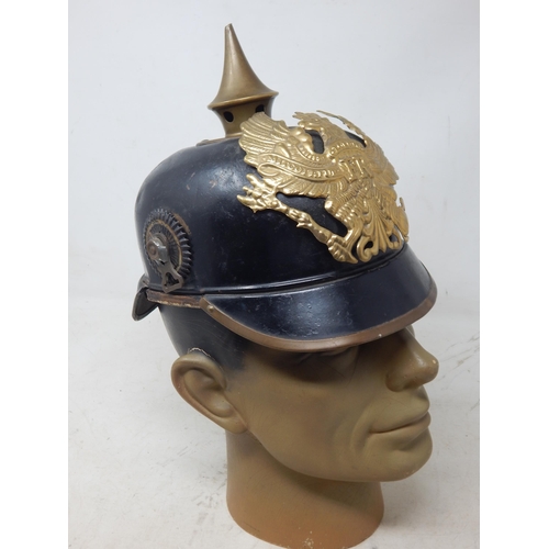 201 - A WWI Imperial German Army pickelhaube uniform helmet. Leather construction with brass front plate d... 
