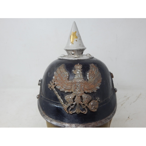 202 - A WWI Imperial German Army pickelhaube uniform helmet. Leather construction with brass front plate d... 