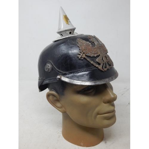 202 - A WWI Imperial German Army pickelhaube uniform helmet. Leather construction with brass front plate d... 