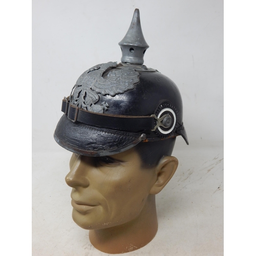 203 - A WWI Imperial German Army pickelhaube uniform helmet with cover. Leather construction with brass fr... 