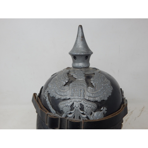 203 - A WWI Imperial German Army pickelhaube uniform helmet with cover. Leather construction with brass fr... 