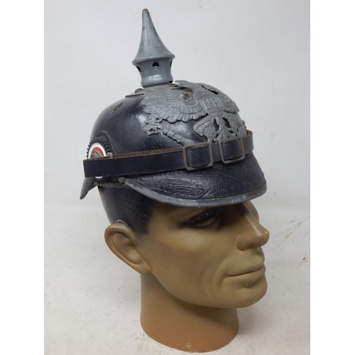 203 - A WWI Imperial German Army pickelhaube uniform helmet with cover. Leather construction with brass fr... 