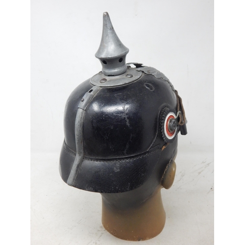 203 - A WWI Imperial German Army pickelhaube uniform helmet with cover. Leather construction with brass fr... 