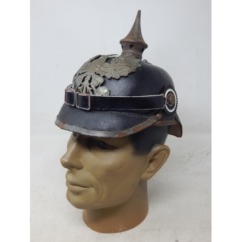 204 - A WWI Imperial German Army pickelhaube uniform helmet with cover. Leather construction with brass fr... 