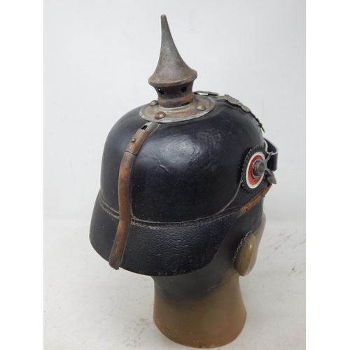 204 - A WWI Imperial German Army pickelhaube uniform helmet with cover. Leather construction with brass fr... 