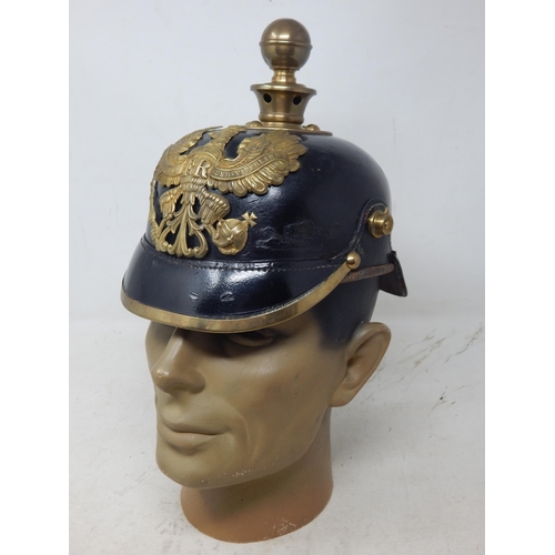 205 - A WWI Imperial German Army pickelhaube uniform helmet. Leather construction with brass front plate d... 