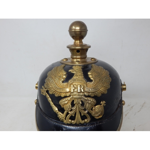 205 - A WWI Imperial German Army pickelhaube uniform helmet. Leather construction with brass front plate d... 