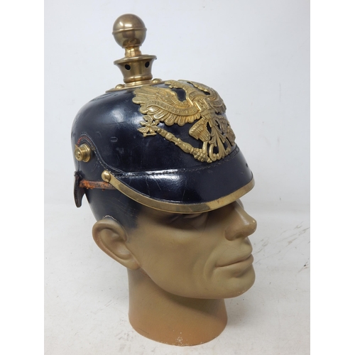 205 - A WWI Imperial German Army pickelhaube uniform helmet. Leather construction with brass front plate d... 