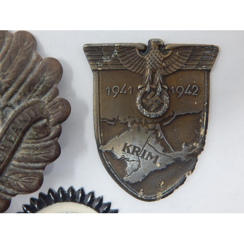 165 - WWI German Pickelhaube Helmet Plate (damaged) together with a WWII German Badge etc