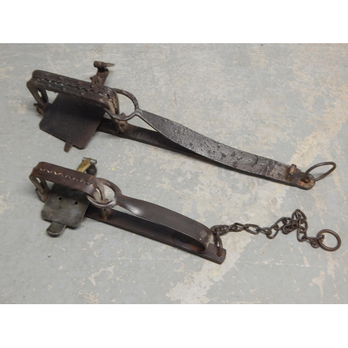 464 - Two 19th Century Cast Iron Traps. Largest 64cm