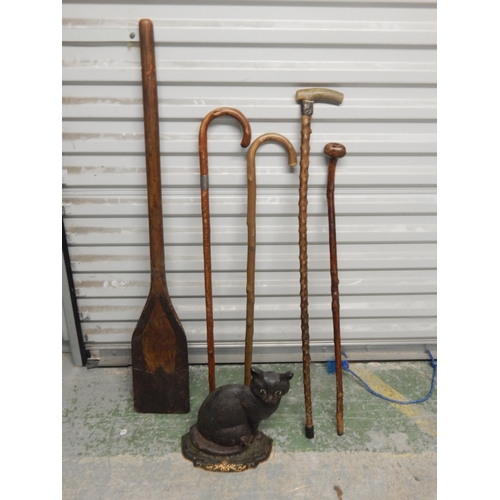 471 - 4 x Walking Sticks, Wooden oar & a Cast Iron Door Stop