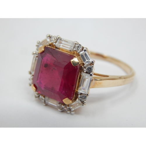 264 - Gold Ring Set with a Central 5.59ct Malagasy Ruby within a Border of White Zircons. Size N/O, gross ... 