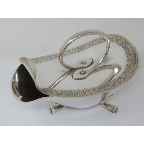 100 - Christopher Dresser (1834-1904). A silver plated 'Crows Foot' design spoon warmer with engraved foli... 