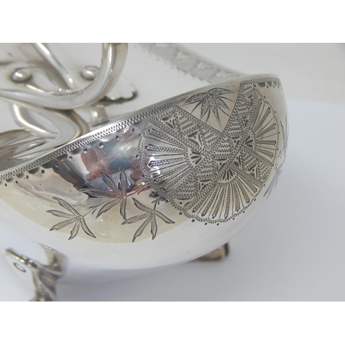 100 - Christopher Dresser (1834-1904). A silver plated 'Crows Foot' design spoon warmer with engraved foli... 