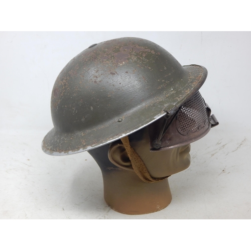 236 - Rare Steel Helmet With Cruise Visor, standard pattern British steel helmet with much of the original... 