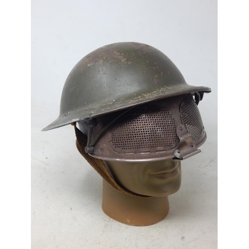 236 - Rare Steel Helmet With Cruise Visor, standard pattern British steel helmet with much of the original... 