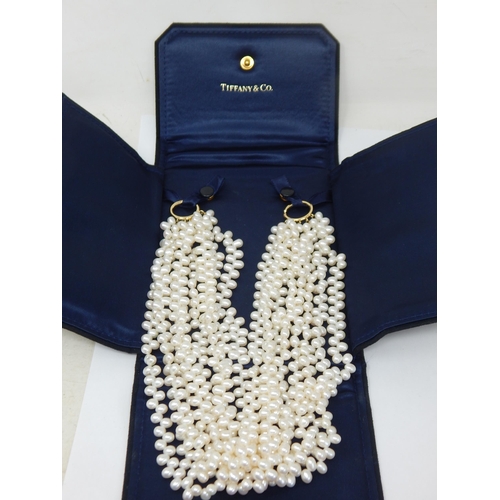 PALOMA PICASSO FOR TIFFANY & CO., A MULTI STRAND FRESHWATER CULTURED PEARL NECKLACE. The eight strands of cream cultured freshwater pearls, to interlocking hooped clasps, signed Paloma Picasso 750 Tiffany & Co., in original Tiffany & Co. suede pouch/case Size/dimensions: 43.5cm long Gross weight: 222 grams: Condition: In Perfect Condition.