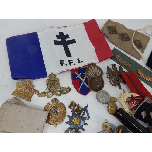 199 - A Box of Interesting Military Items Including Cloth Badges, Foreign Legion Armband, Cap & Pin Badges... 