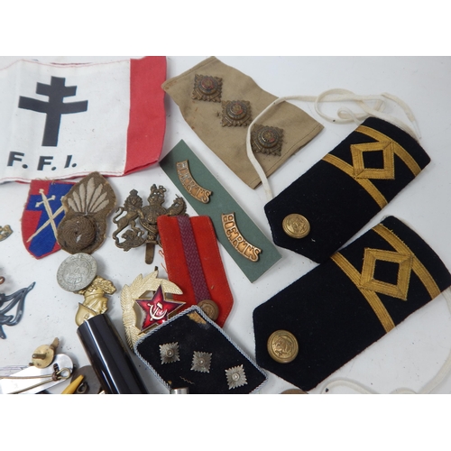 199 - A Box of Interesting Military Items Including Cloth Badges, Foreign Legion Armband, Cap & Pin Badges... 