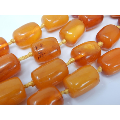 216 - Antique 9ct Gold Clasped Butterscotch Amber Double Strand Individually Knotted Necklace: Length 56cm... 