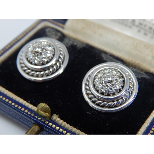 229 - A Pair of Palladium Diamond Set Earrings: Each Earring Comprises a central diamond within a border o... 