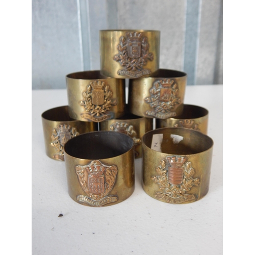 A Quantity of WWI Military Badged Trench Art Brass Napkin Rings (8)