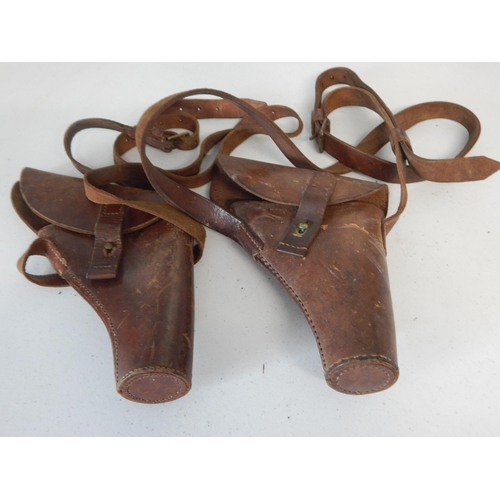 975 - WWII Gun Holsters, one dated 1944 on Shoulder belts (2)