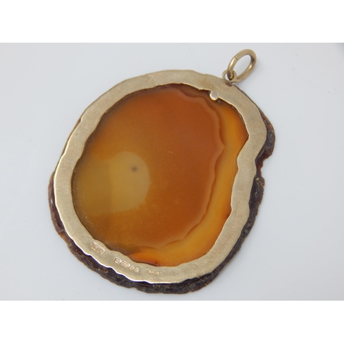 23 - GUCCI:  A Large 9ct Gold Mounted Agate Pendant Hallmarked London 1978 by Gucci: Measuring 5cm x 4cm