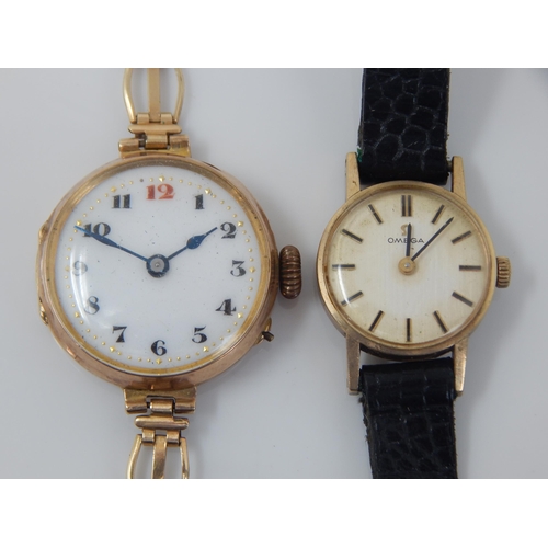 162R - 9ct Gold Omega Ladies Wristwatch on Black Leather Strap together with a further 9ct Gold Wristwatch ... 