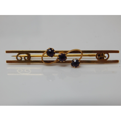 123 - Antique 9ct gold three-stone amethyst bar brooch (pin not gold) gross 1.4g