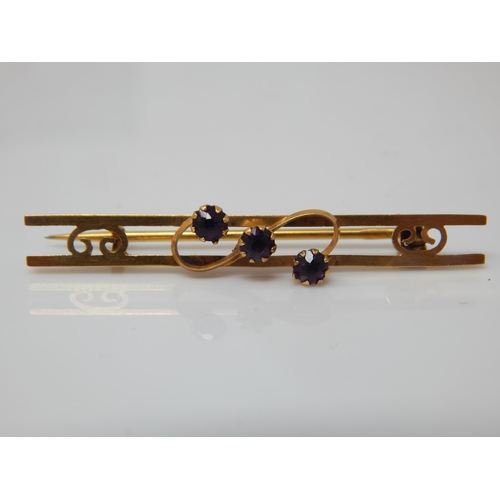 123 - Antique 9ct gold three-stone amethyst bar brooch (pin not gold) gross 1.4g