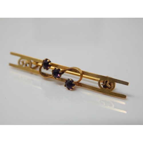 123 - Antique 9ct gold three-stone amethyst bar brooch (pin not gold) gross 1.4g