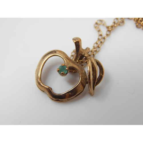 138 - Vintage 9ct gold London hallmarked pendant in the form of an apple set an emerald on a 9ct gold chai... 