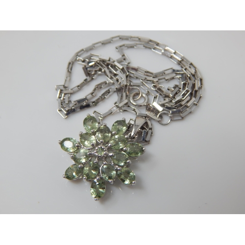 140 - A green sapphire star pendant set in 9ct white gold (24mm incl bale) on matching large link chain (4... 