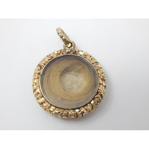 143 - Early C19 yellow metal glazed mourning locket with lock of hair – 4.5g gross